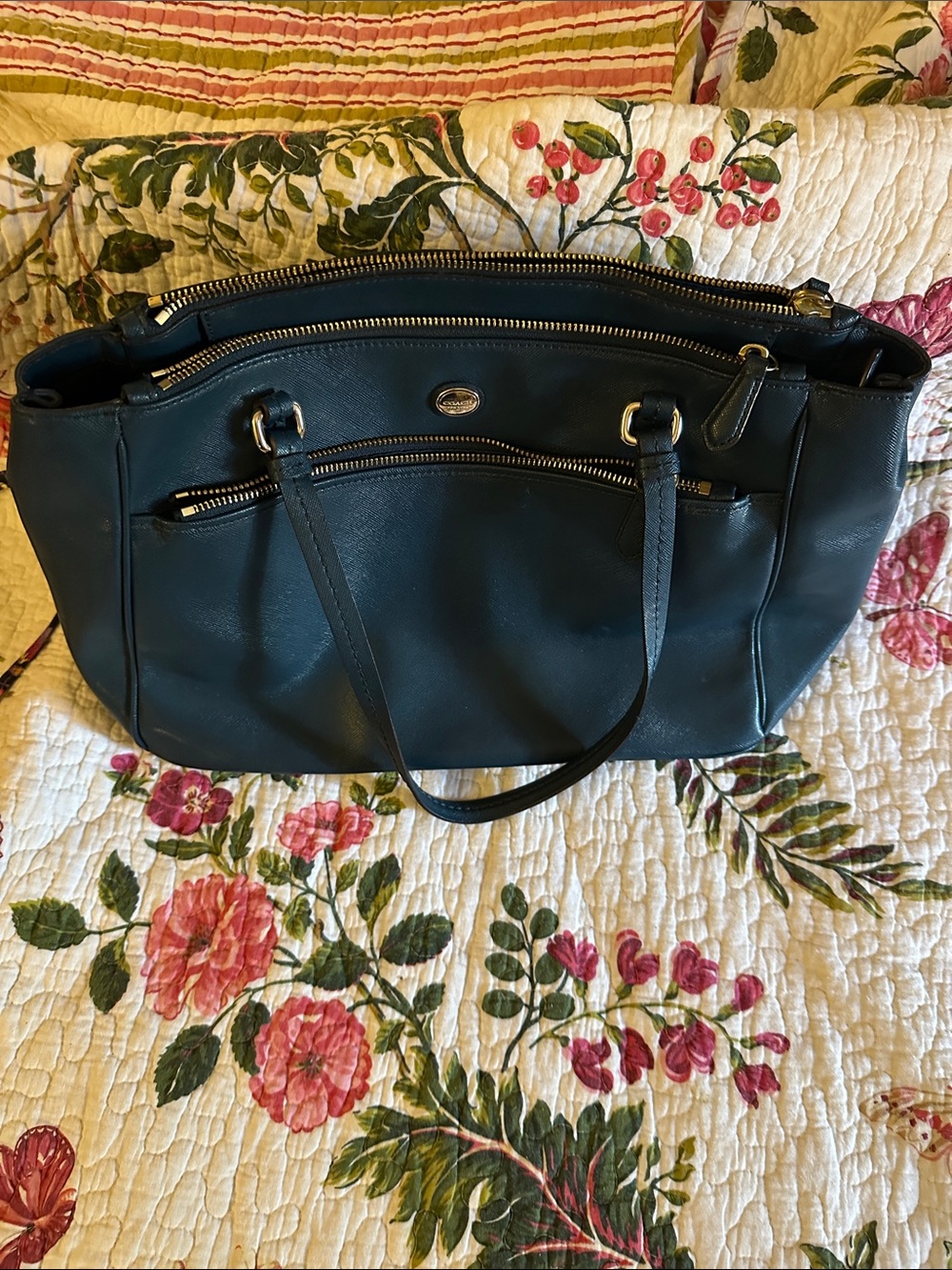 Coach classic navyTote Bag with Gold Hardware.Has three zipper spaces.